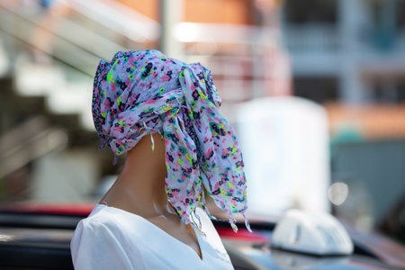 A colorful shawl turban on the mannequin's head.