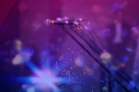 Microphones in colorful beams of stage light.の写真素材