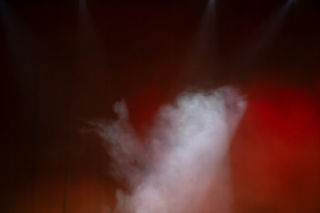 Red blurred background with puffs of white smoke.の写真素材
