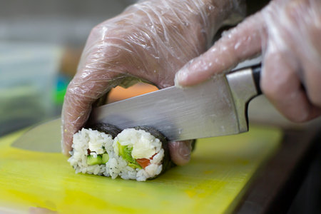 Close up of man japanese restaurant chef cooking sushi in the kitchen