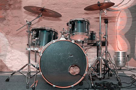 Retiro drum set on pink brick background.