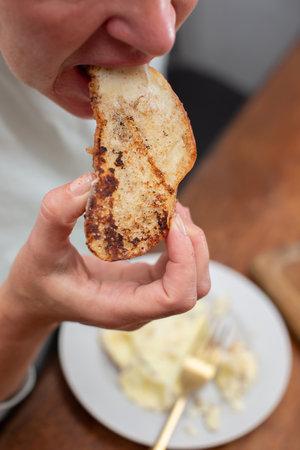 The woman's hands hold toasted toast. Eat food.の写真素材