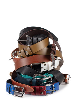 View of various colorful leather belts stacked in a pile. Isolated on white backgroundの写真素材