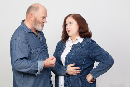 Portrait of an elderly couple in love. They argue and discussの写真素材