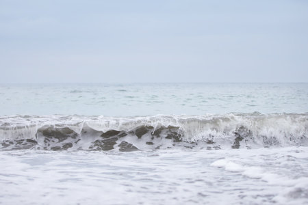 Beautiful foamy breeze from the waves of the sea close-up.