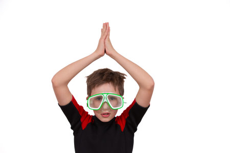 A little boy in swimming goggles depicts diving. A swimmer on a white background.の写真素材