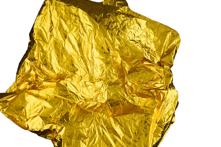 Texture of crumpled gold foil paper on a white background.の写真素材