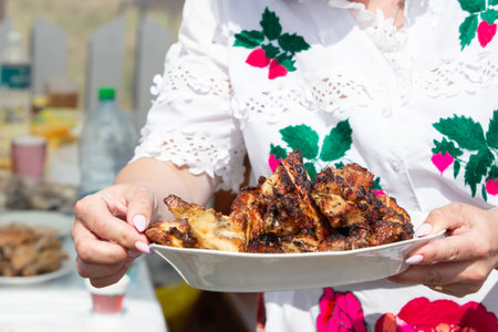 Hands holding the national dish fried meat.の写真素材