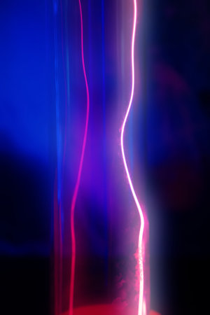A glass tube with red and blue light from the gas.の写真素材