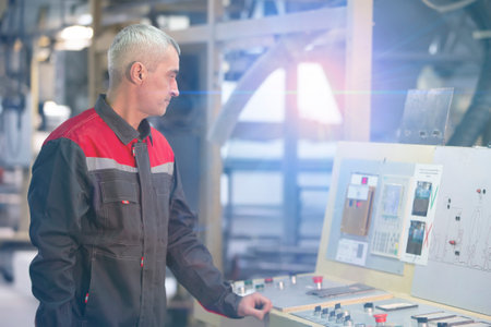 A worker at an enterprise at a computer-controlled machine.