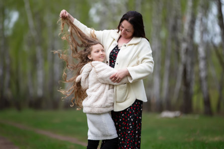 Mom and daughter are walking in the park.の写真素材