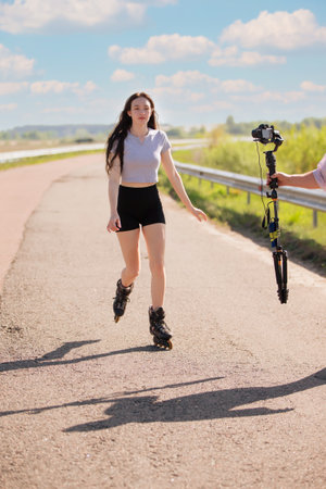 A woman rollerblades on the road.の写真素材