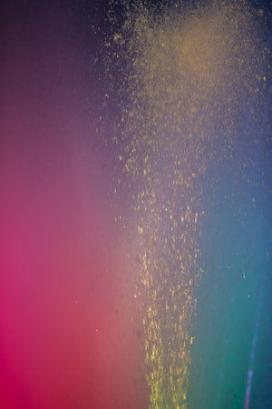 A colorful background with a splash of gold and purple. The colors are vibrant and the gold is scattered throughout the imageの写真素材