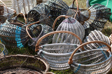 Wicker baskets at a craft fair. There are many of them, all piled up.