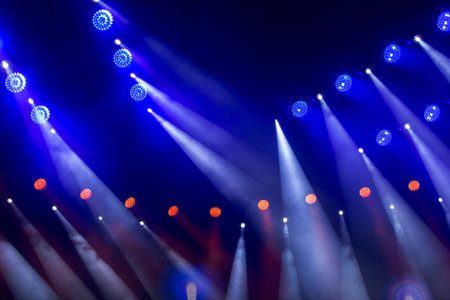 Stage white beams of light on dark blue background. Stage lighting for a concert.