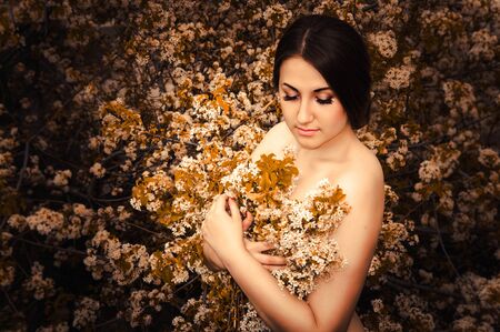 Beautiful young girl with flowersの写真素材