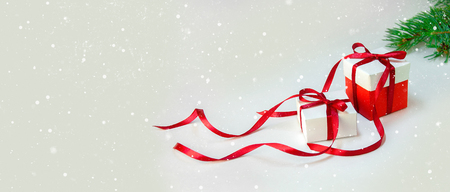 Christmas Gift's in White Box with Red Ribbon on Light Background. New Year Holiday Composition Banner. Copy Space For Your Textの写真素材
