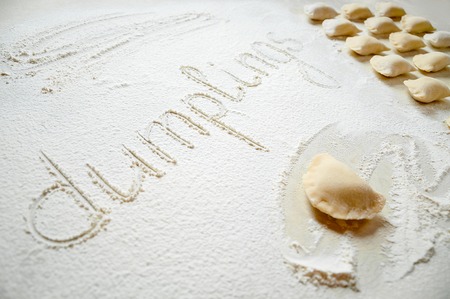 Dumplings with potatoes on white background. Traditional Ukrainian food. Cooking raw dumplings with potatoesの写真素材