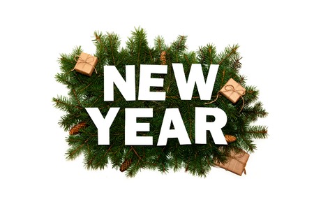 Words New Year on Green Fir Branches with Small Gift Boxs on Light Background. Creative Nature Concept. Minimal Holiday Composition. Flat Layの写真素材