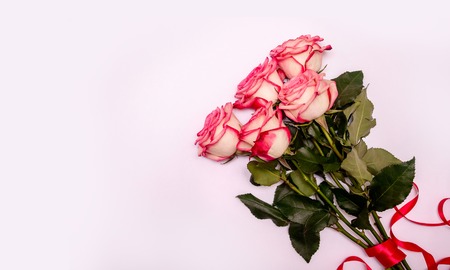 Bouquet Pink Roses on a White Background. Concept International Woman Day 8 March, Valentines Day, Greeting Card, Declaration of Love. Flat Lay. Copy Space For Your Textの写真素材