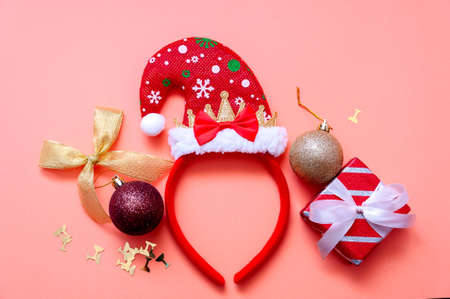 Christmas Composition with Gift Boxes, Santa Hat and Decorations on Pink Backgroundの写真素材