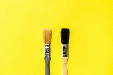 Color of the Year 2021. Gray Brushes on Yellow Background. Concept Repairの写真素材