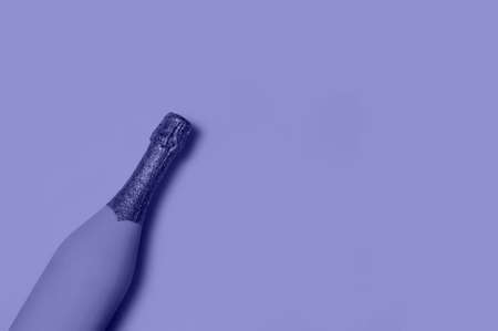 Festive Minimalistic Champagne Bottle on Blue Background. Creative Concept. Very Peri - Color of the year 2022.の写真素材