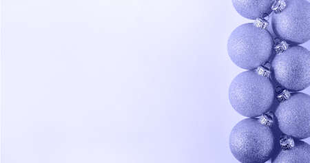 Trendy color of tear 2022 Very Peri. Christmas Pink Ball on Light Background. Minimal New Year Holiday Composition.の写真素材