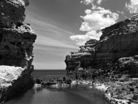 Australia. Great Ocean Road. Flaky limestone with rocky lake, monochrome.の写真素材