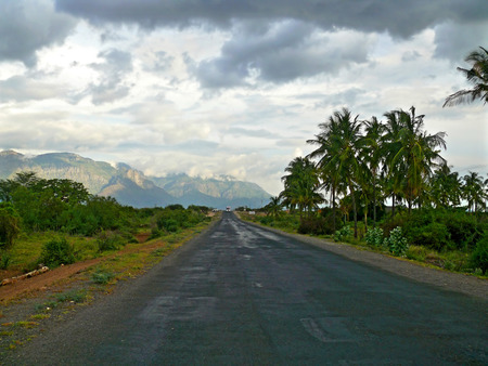 The cloudy sky. The car was on the road. Mountains in the distance. Tanzania, Africa. The rainy...