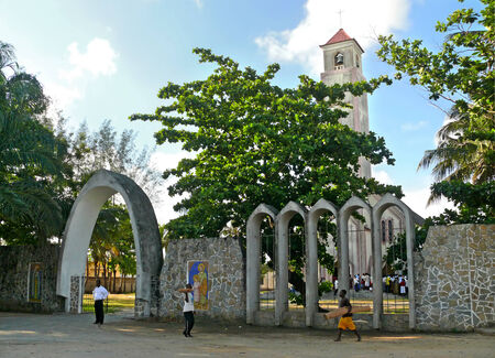 QUELIMANE, MOZAMBIQUE - 7 DECEMBER 2008: The Church building in Quelimane, Mozambique - 7 December 2008. Unknown people near the gate in the Church and join the Church building. のeditorial素材