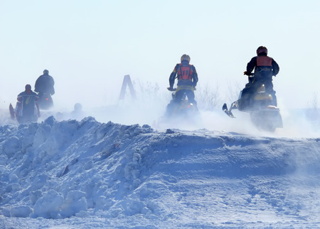Nadim, Russia - April 12, 2008: Unknown athletes snowmobile race on speed. Snow cross-country race. Jump.のeditorial素材