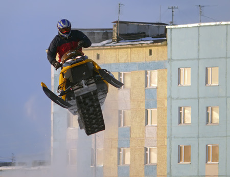 Nadim, Russia - February 21, 2009: Snoukross. Vadim Vasuhin in  jump with springboard on snowmobile during snow cross-country race.のeditorial素材
