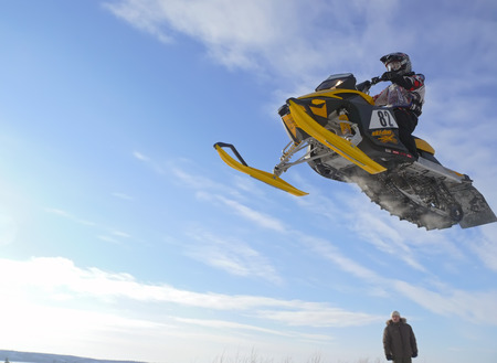 Nadim, Russia - February 28, 2009: Snoukross. Vadim Vasuhin in  jump with springboard on snowmobile...