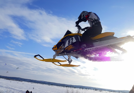 Nadim, Russia - February 28, 2009: Snoukross. Vadim Vasuhin in  jump with springboard on snowmobile...