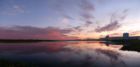 Nadym, Russia - June 20, 2008: the city of Nadym river Nadym in Nadym, Russia - June 20, 2008. Quay. Sunset over the city.の写真素材