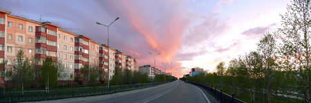 Nadym, Russia - June 20, 2008: the City skyline in Nadym, Russia - June 20, 2008. City Central road with riding on her car. Sunset over the city.のeditorial素材