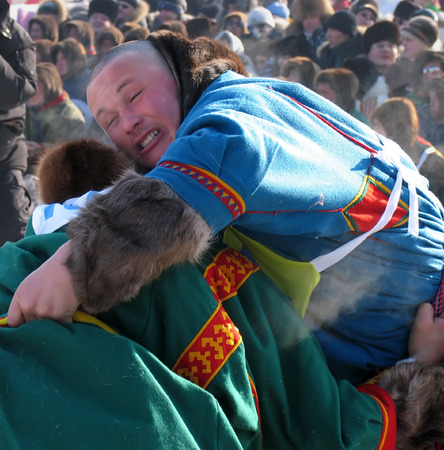 NADYM, RUSSIA - March 17, 2006: National Holiday - Day of the reindeer herders. The wrestling unknown men on holiday in Nadym, Russia - March 17, 2006.のeditorial素材