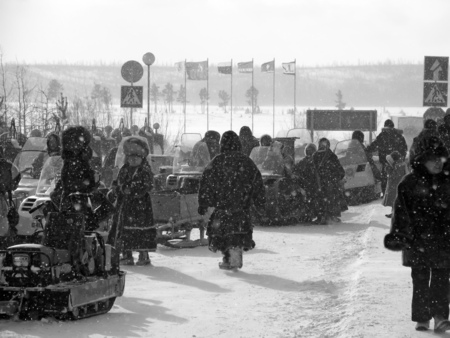 Nadym, Russia - March 11, 2005: the national holiday, the day of the reindeer herder in Nadym, Russia - March 11, 2005. Snowmobiles parked on the roadside. Strangers near snowmobiles.のeditorial素材