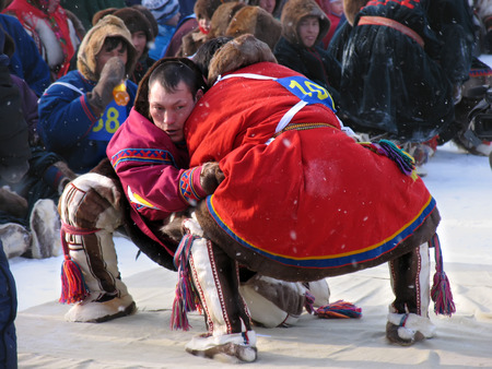 NADYM, RUSSIA - March 11, 2005: National Holiday - Day of the reindeer herders. The wrestling unknown men on holiday in Nadym, Russia - March 11, 2005.のeditorial素材