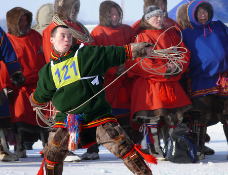Nadym, Russia - March 15, 2008: the national holiday - the Day of the reindeer herder in Nadym, Russia - March 15, 2008. Sports competitions. Unknown man throws lasso.のeditorial素材