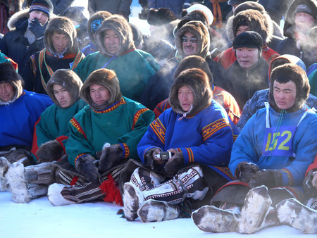 Nadym, Russia - March 15, 2008: the national holiday - the Day of the reindeer herder in Nadym, Russia - March 15, 2008. A crowd of unfamiliar men Nenets sit and watch the view.のeditorial素材