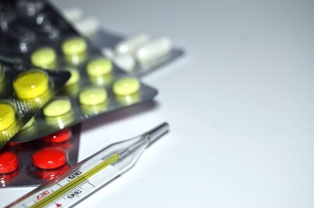 medicines red and yellow with copy of the spray on a white background