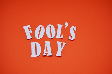 cut letters April April Fool's Day on an orange backgroundの写真素材
