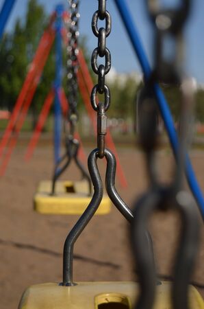 swing on the chain close-up at the playground in the park vertical orientationの写真素材
