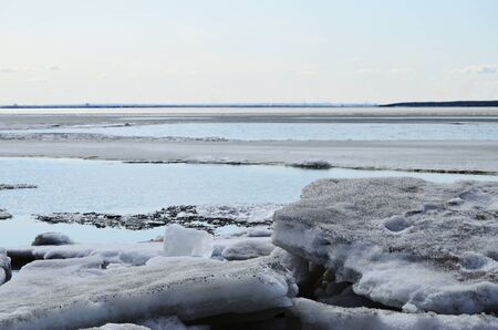 dirty melted ice close-up against the backdrop of ice on a sunny spring day horizontal orientationの写真素材