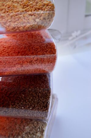 jars of cereal lentil buckwheat oatmeal lined on top of each other look on the sideの写真素材
