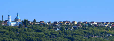 panorama of the city with trees and church, city views, travel, blue sky, landscapeの写真素材