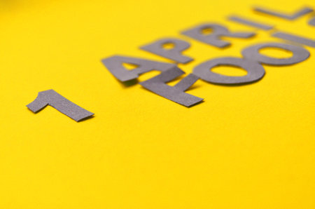 Figure 1 in the inscription April Fools Day close-up, gray letters on a yellow background in the style of minimalismの写真素材