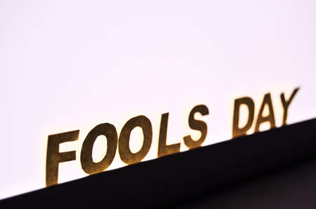 Image caption Fools' Day of yellow letters on the background of a white LED lamp with a copy space....